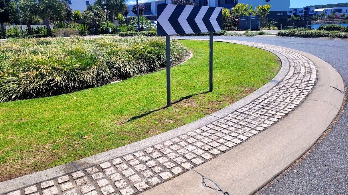 Maintained kerbside median and turf on a suburban street